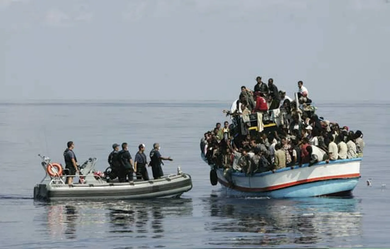Italian coastguards intercept a boatload of illegal migrants
