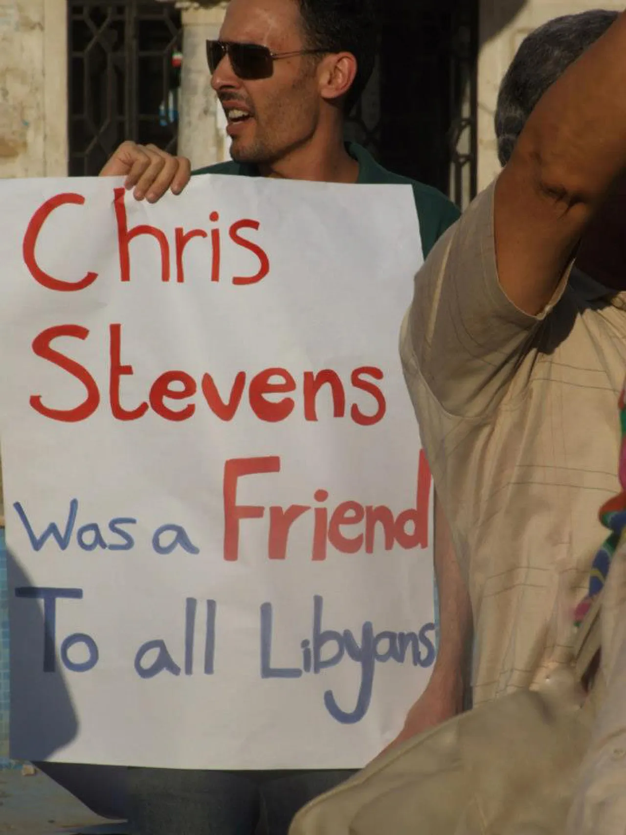 A protester in Benghazi holds a placard expressing a sentiment felt amongst many Libyans.