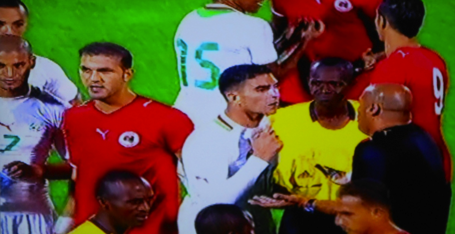 The referee and some Algerian players as they try to convince Albrich (Libya’s coach) and the Libyan players not to leave the field following abusive and intimidating chants from the Algerian crowd. (Photo: Mohamed Assed)