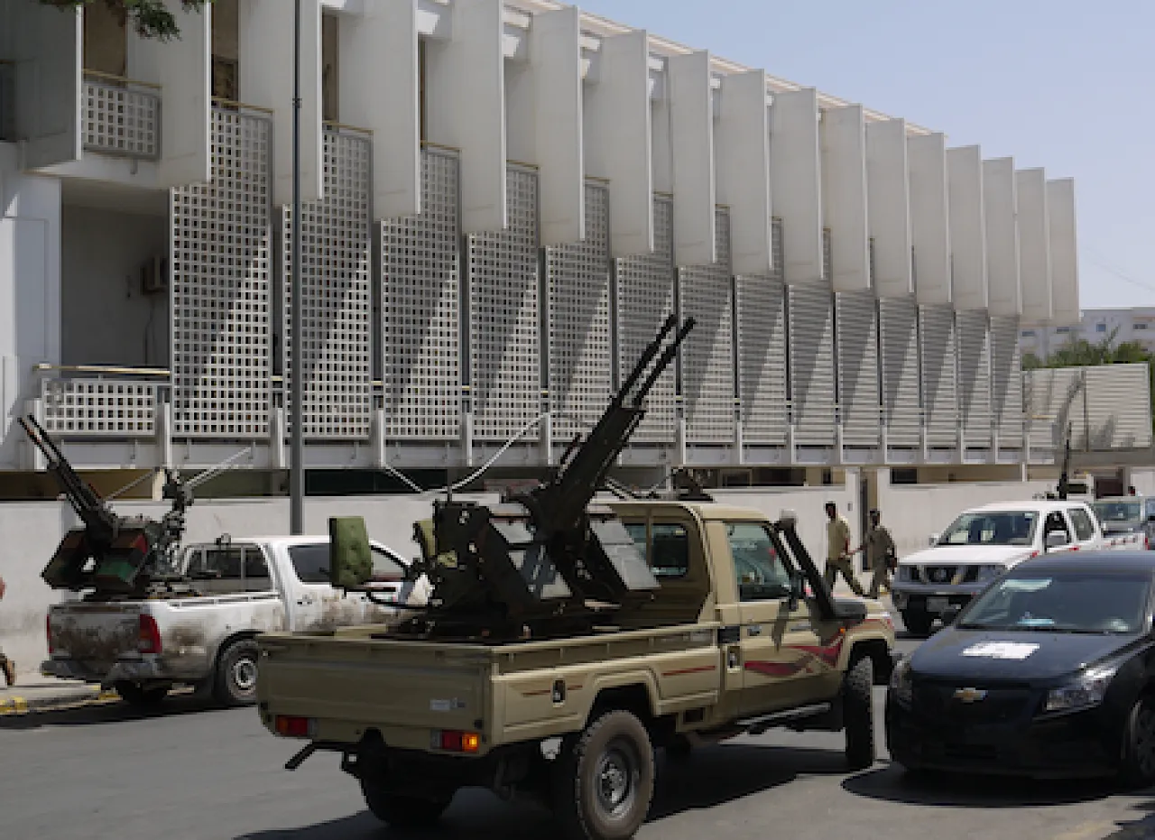 Weapons equal power. Militia vehicles parked outside the prime minister's office at a protest on 1 July. (Photo: George Grant)