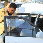Misrata youth remove tinted car windows