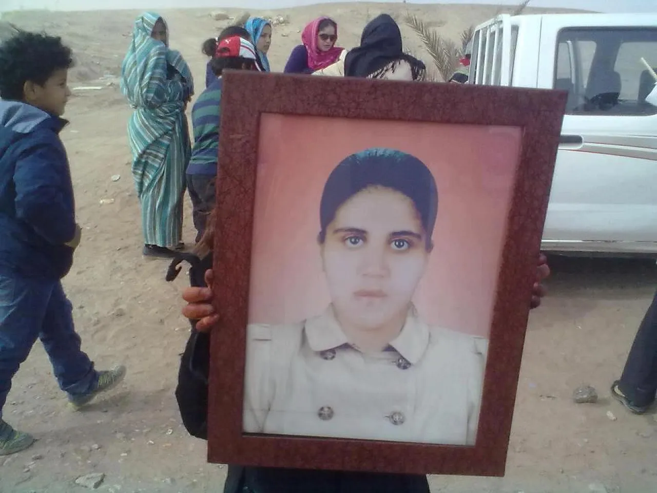 Protestor with a picture of Unood Senussi