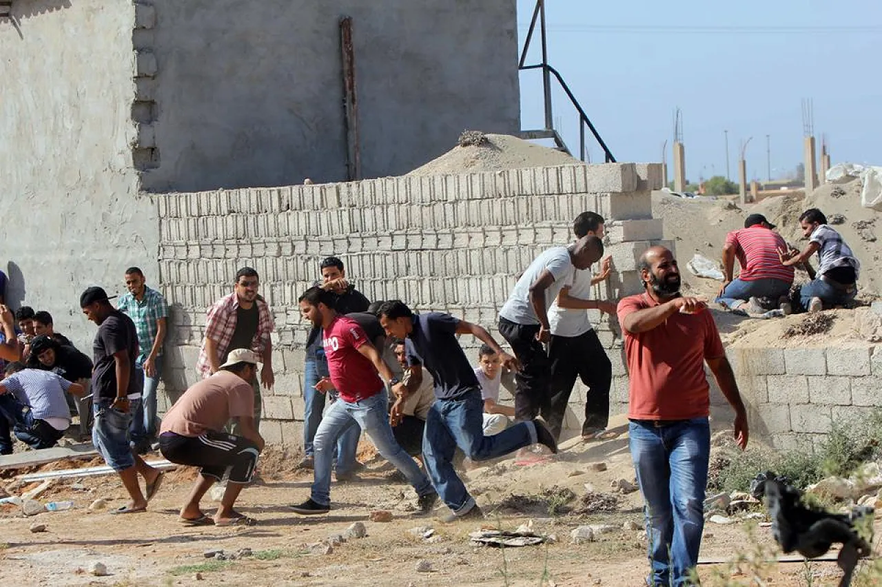 Bengahzi Shield 2 Protestors take cover in fighting at Libya Shield headquarters
