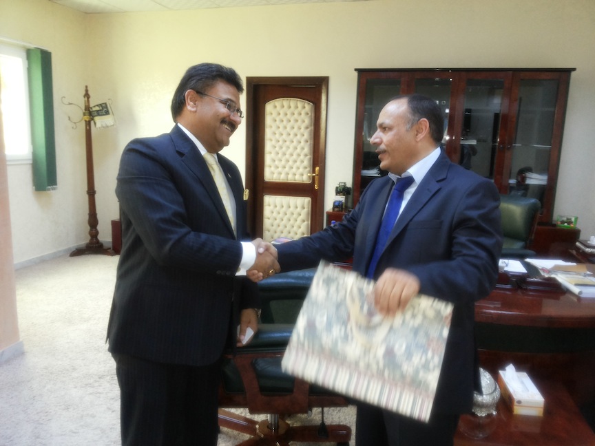 Agriculture Minister Saleh Hamed Mahjoub shakes hands with the Indian Ambassador