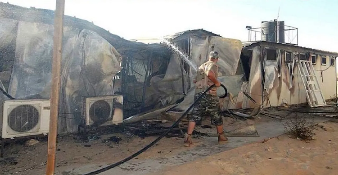 Awjala attack A PFG member puts out the fire at the camp