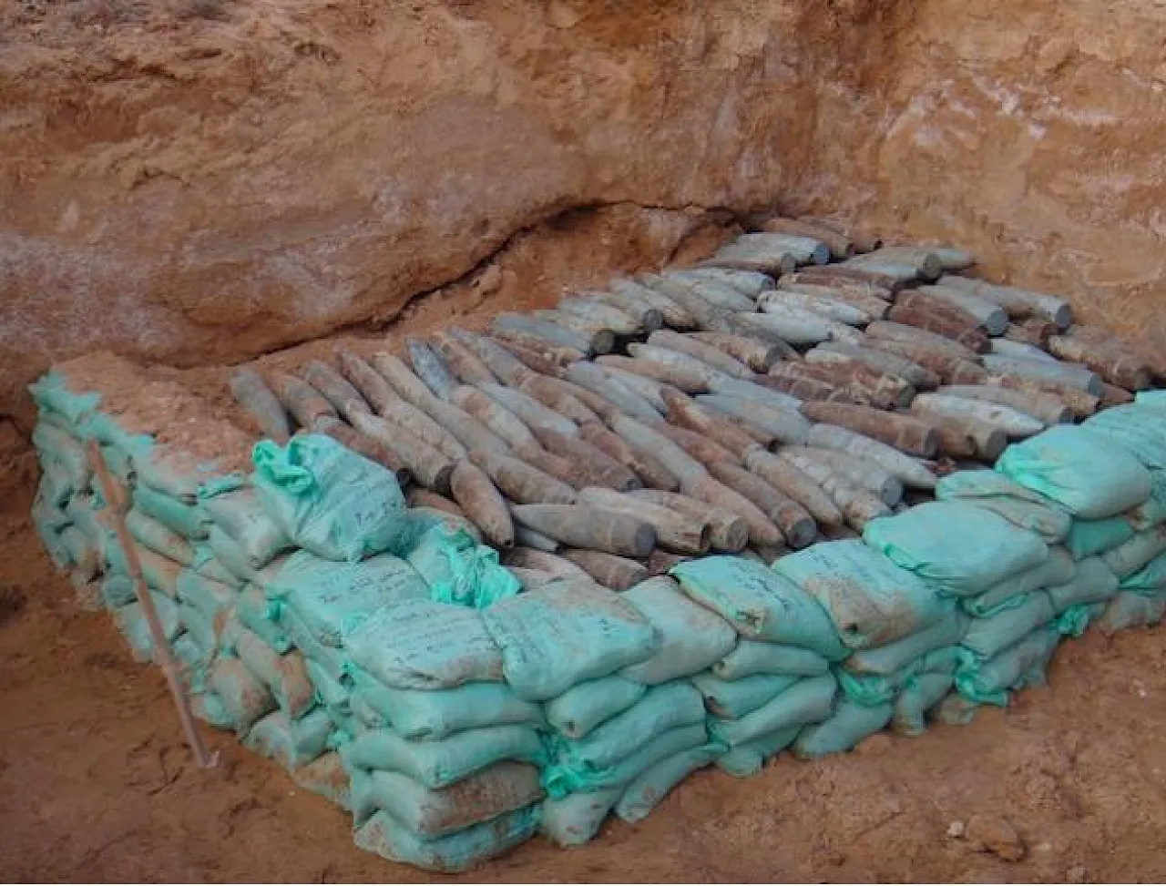 557 high explosive projectiles are carefully stacked in preparation for the demolition (Photo: Handicap International)