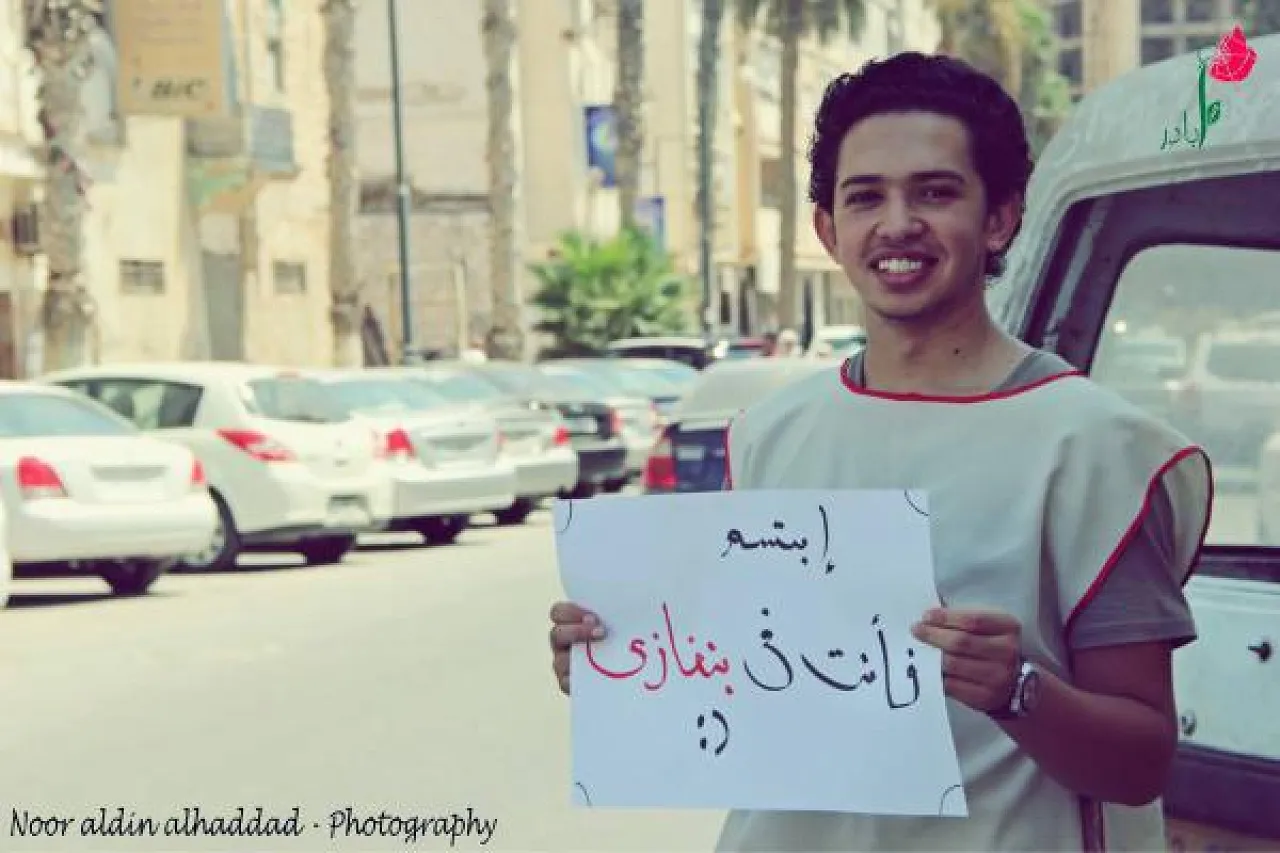 Murdered blogger holding sign reading "Smile you are in Benghazi"