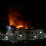 Fight for Benghazi port continues as fire rages in downtown hospital