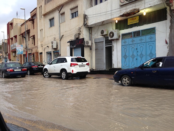 Motorists navigate a flooded street in Ben Ashour