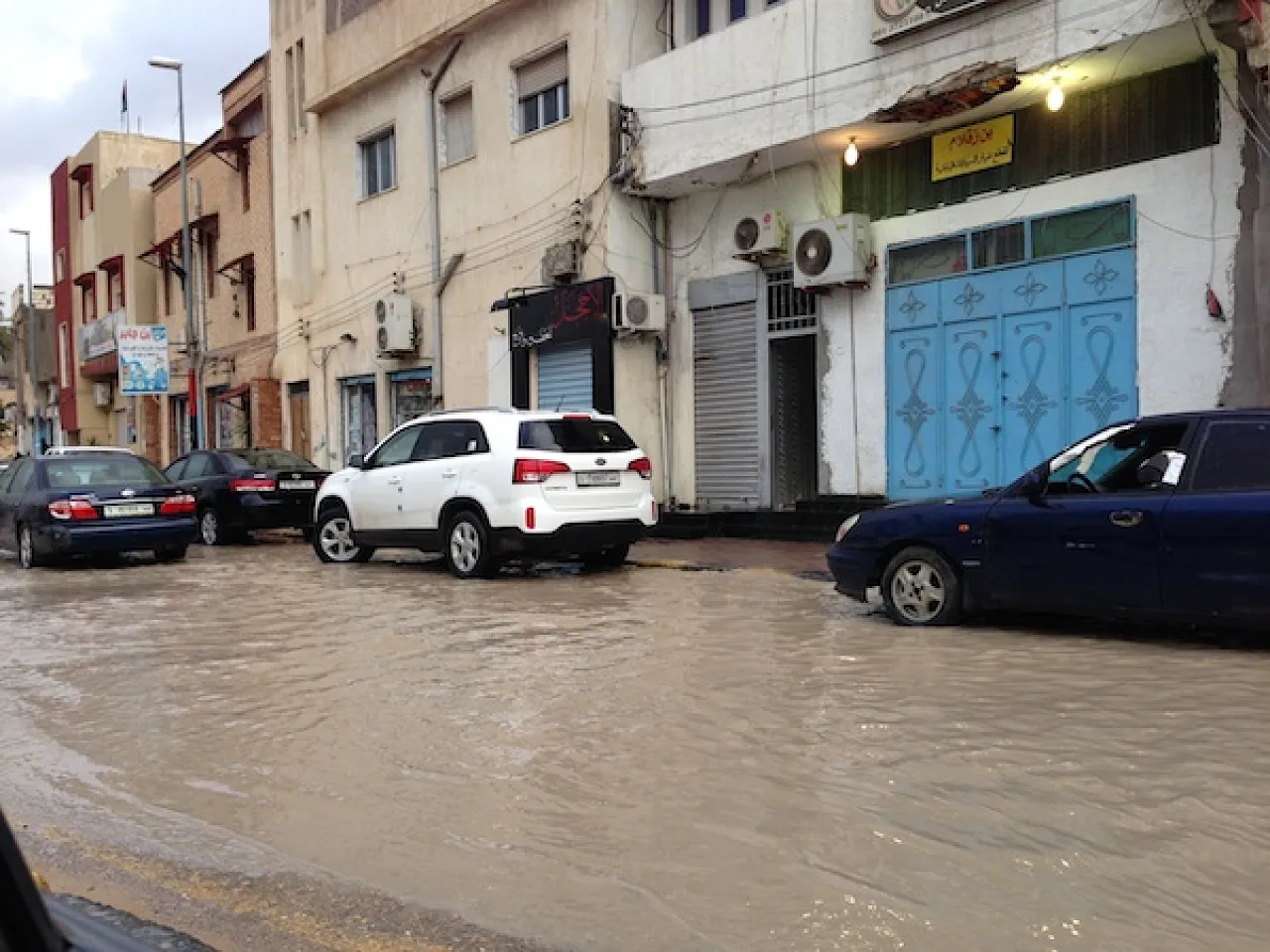 Motorists navigate a flooded street in Ben Ashour