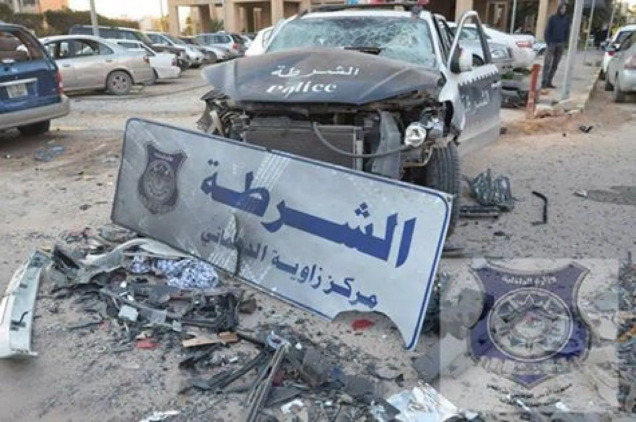 Rubble and a wrecked police vehicle outside the police station (Photo: Tripoli interior ministry)