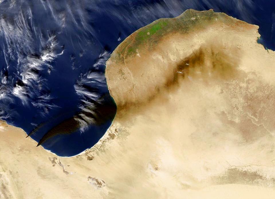 Black plumes from oil tank fires seen from space