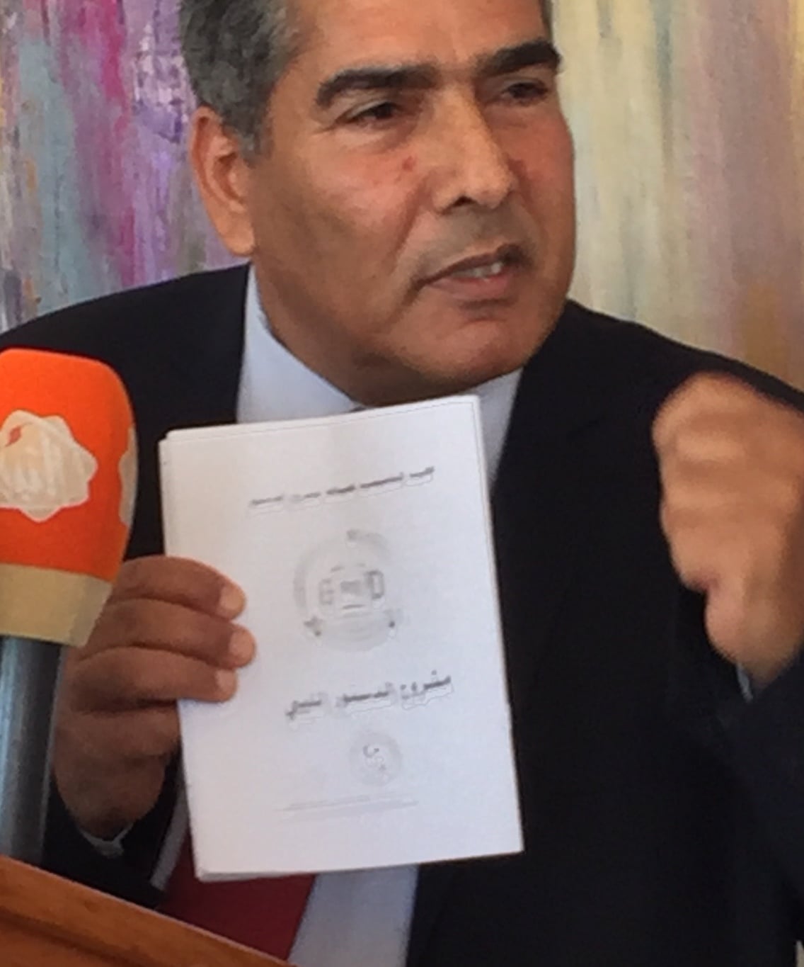 CDA member Omar Mohamed Ali with the CDA's final draft (Photo: Libya Herald)