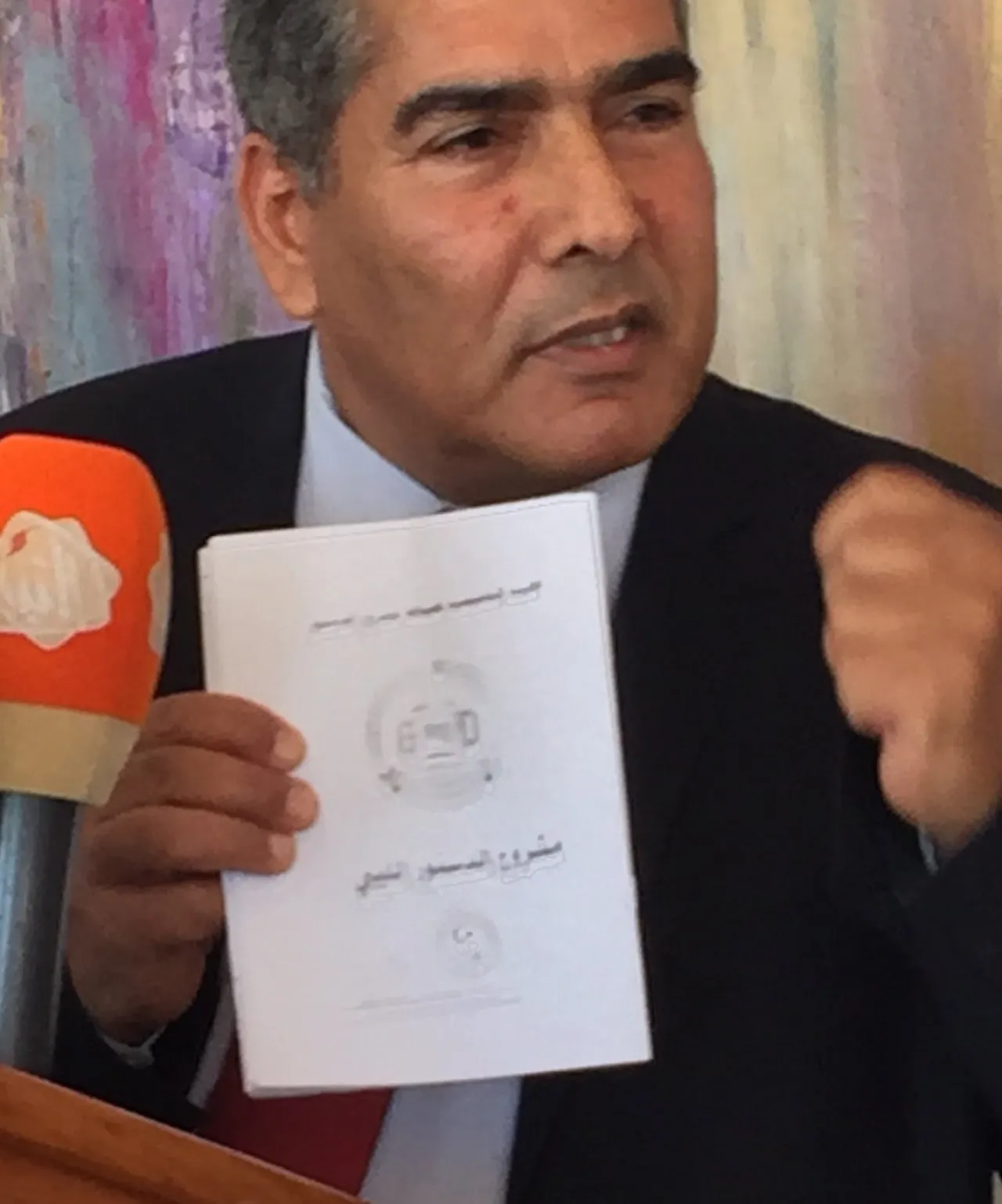 CDA member Omar Mohamed Ali with the CDA's final draft (Photo: Libya Herald)
