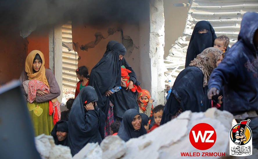 The fearful faces of defeat. Women with children flee over the rubble (Photo: